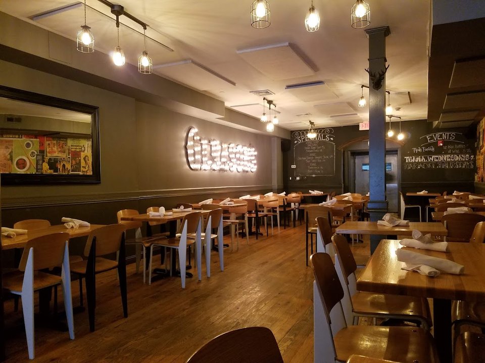 Pizza restaurant interior with bar seating and casual tables